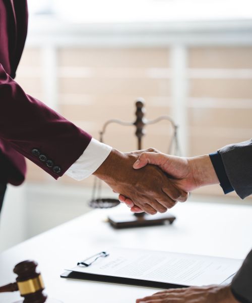Portrait of lawyer in law office hand shake giving advice and advice on lawsuit consulting concept